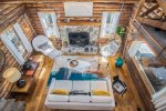 Living room boasts soaring two story ceilings and a wood burning fireplace for winter months